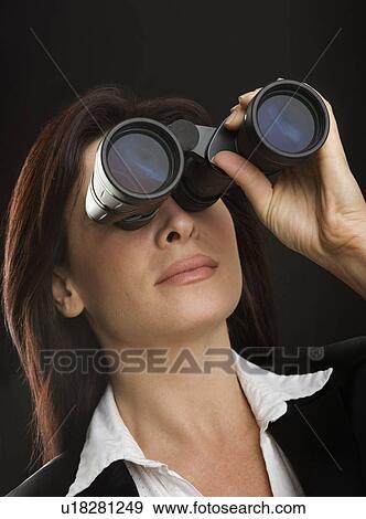 Woman looking through binoculars View Large Photo Image Stock Photo - Woman looking through binoculars. Fotosearch