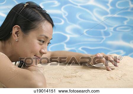 Woman lying on sand View Large Photo Image Stock Image - Woman lying on sand. Fotosearch