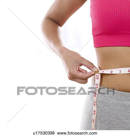 Woman measuring waistline View Large Photo Image Stock Photo - Woman measuring waistline. Fotosearch