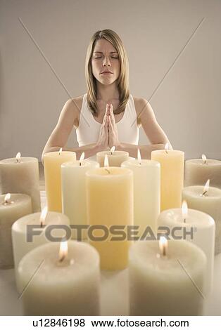 Woman meditating by candlelight View Large Photo Image Stock Photo - Woman meditating by candlelight. Fotosearch
