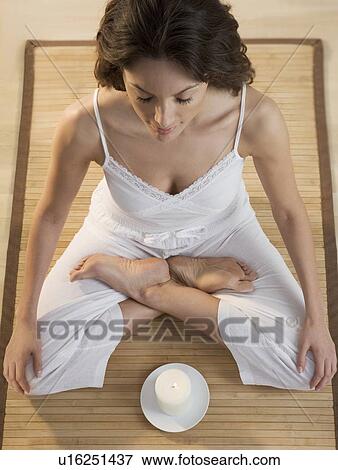 Woman meditating with candle View Large Photo Image Stock Photo - Woman meditating with candle. Fotosearch