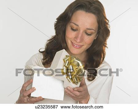 Woman opening gift box View Large Photo Image Stock Photo - Woman opening gift box. Fotosearch
