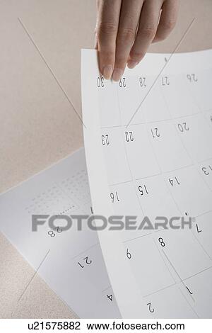 Stock Image - Woman paging through calendar. Fotosearch