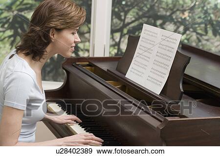 Woman playing piano View Large Photo Image Stock Photo - Woman playing piano. Fotosearch