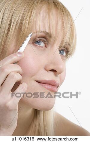 Woman plucking eyebrows View Large Photo Image Stock Photograph - Woman plucking eyebrows. Fotosearch