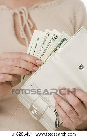 Woman putting cash in wallet View Large Photo Image Stock Image - Woman putting cash in wallet. Fotosearch