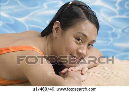 Stock Image - Woman reclining in swimsuit. Fotosearch