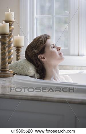 Woman relaxing in bathtub View Large Photo Image Stock Image - Woman relaxing in bathtub. Fotosearch