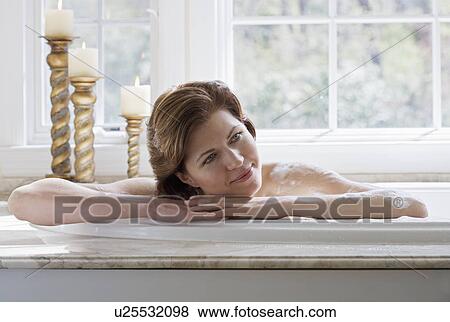 Stock Photo - Woman relaxing in bathtub. Fotosearch