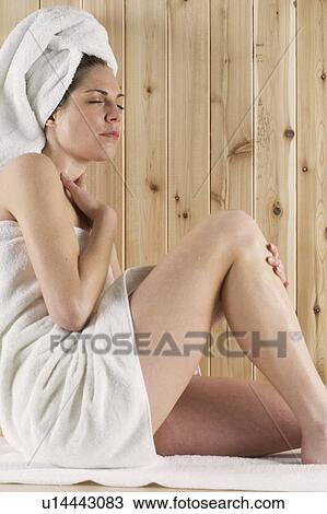 Stock Image - Woman relaxing in sauna. Fotosearch