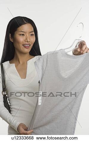 Woman shopping for dress View Large Photo Image Stock Photo - Woman shopping for dress. Fotosearch