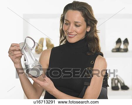 Stock Image - Woman shopping for shoes. Fotosearch