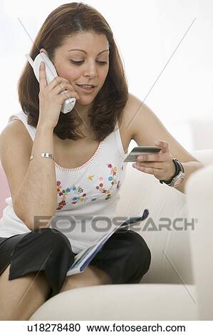Stock Image - Woman shopping on phone. Fotosearch