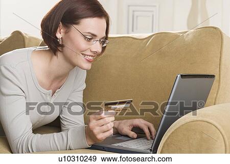 Stock Photo - Woman shopping online. Fotosearch