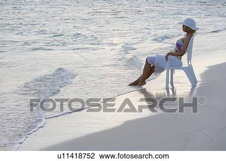 Woman sitting at the beach View Large Photo Image Stock Image - Woman sitting at the beach. Fotosearch