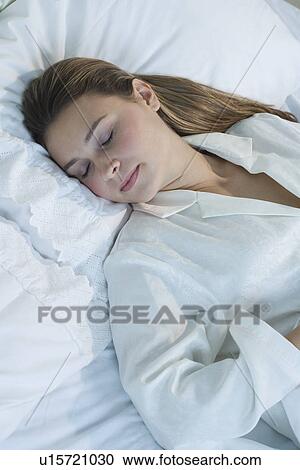 Stock Image - Woman sleeping in bed. Fotosearch