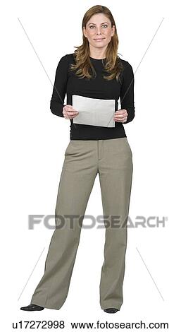 Stock Photo - Woman standing holding papers. Fotosearch