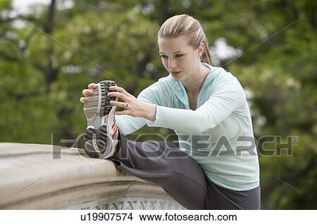 Woman stretching in park View Large Photo Image Picture - Woman stretching in park. Fotosearch
