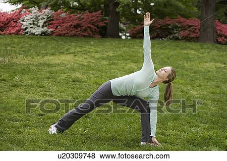 Stock Photo - Woman stretching in park. Fotosearch