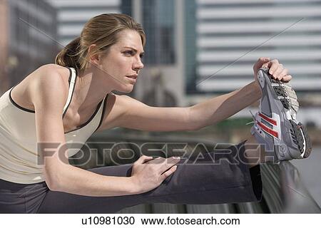 Woman stretching outside View Large Photo Image Stock Image - Woman stretching outside. Fotosearch