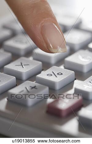 Woman using a calculator View Large Photo Image Stock Photography - Woman using a calculator. Fotosearch