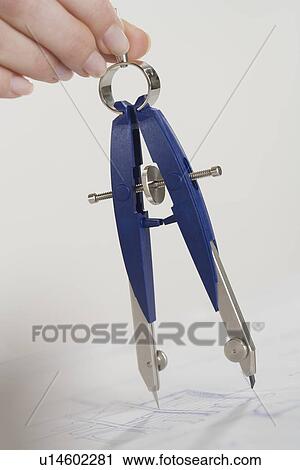 Stock Image - Woman using a protractor. Fotosearch