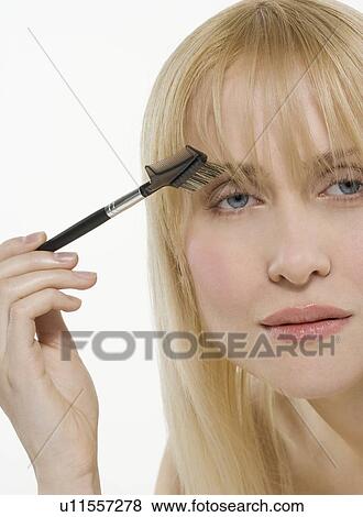 Stock Photo - Woman using cosmetic brush. Fotosearch