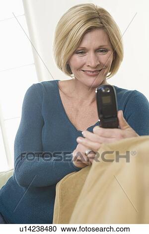 Stock Image - Woman using mobile telephone. Fotosearch