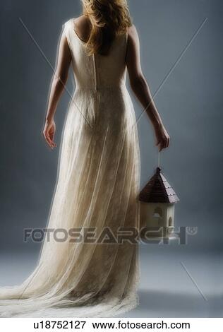 Woman wearing a long white dress View Large Photo Image Stock Photo - Woman wearing a long white dress. Fotosearch