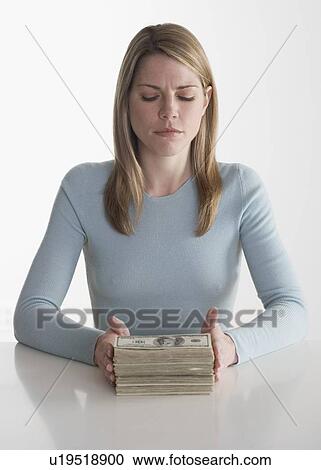 Stock Image - Woman with a stack of money. Fotosearch