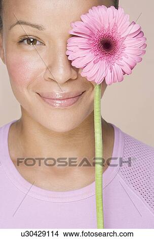 Woman with flower over one eye View Large Photo Image Picture - Woman with flower over one eye. Fotosearch