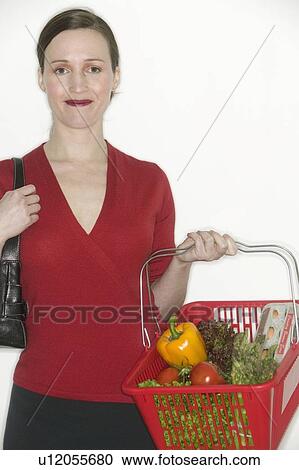 Stock Image - Woman with grocery basket. Fotosearch