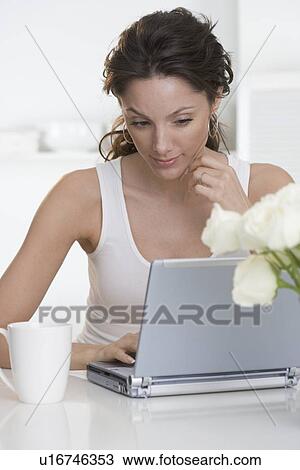 Woman with laptop and coffee cup View Large Photo Image Stock Image - Woman with laptop and coffee cup. Fotosearch