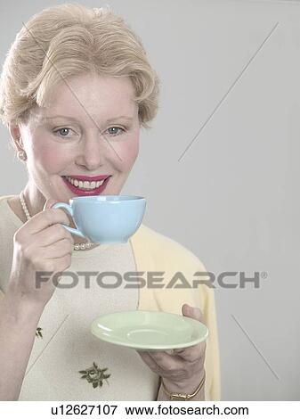 Woman with teacup and saucer View Large Photo Image Stock Photo - Woman with teacup and saucer. Fotosearch