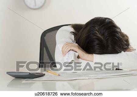 Stock Photograph - Woman working on paperwork. Fotosearch