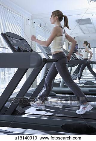 Woman working out on treadmill View Large Photo Image Stock Photo - Woman working out on treadmill. Fotosearch