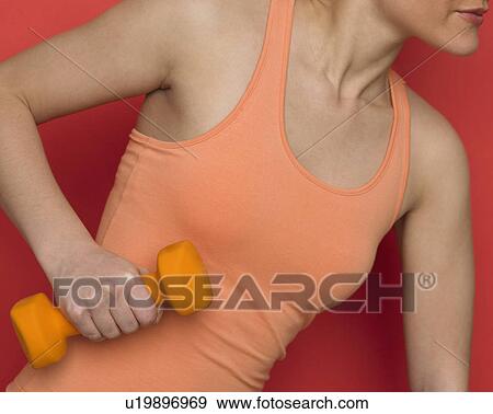 Woman working out with dumbbell View Large Photo Image Stock Photo - Woman working out with dumbbell. Fotosearch