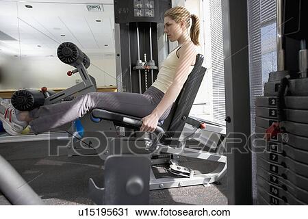 Woman working with resistance machine View Large Photo Image Stock Image - Woman working with resistance machine. Fotosearch