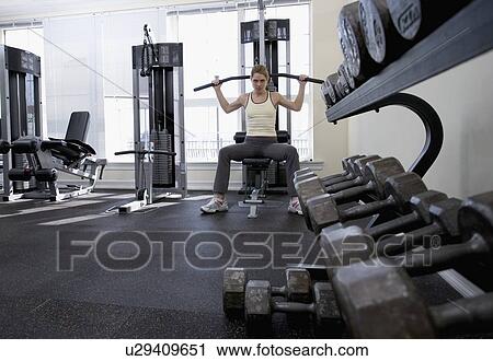 Woman working with resistance machine View Large Photo Image Stock Image - Woman working with resistance machine. Fotosearch