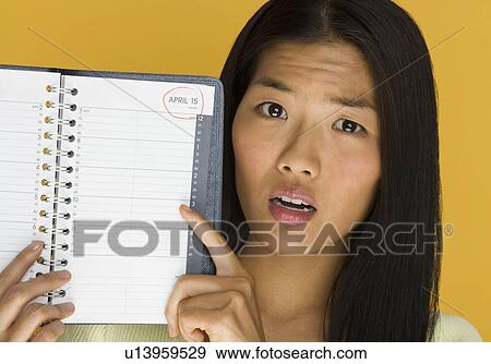 Woman worried about tax deadline View Large Photo Image Stock Photo - Woman worried about tax deadline. Fotosearch