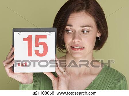 Stock Photo - Woman worried about tax deadline. Fotosearch