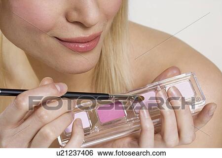 Woman's hands with cosmetics and brush View Large Photo Image Stock Photograph - Woman's hands with cosmetics and brush. Fotosearch