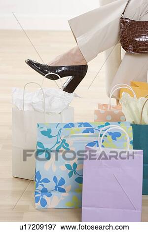 Woman's leg with shopping bags View Large Photo Image Stock Photo - Woman's leg with shopping bags. Fotosearch
