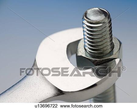 Wrench turning nut on bolt View Large Photo Image Stock Image - Wrench turning nut on bolt. Fotosearch