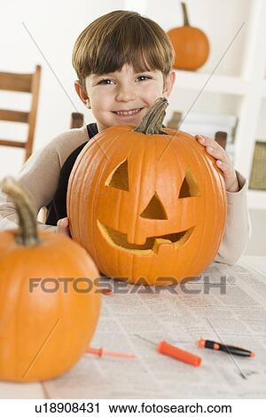 Young boy with a jack o lantern View Large Photo Image Stock Image - Young boy with a jack o lantern. Fotosearch