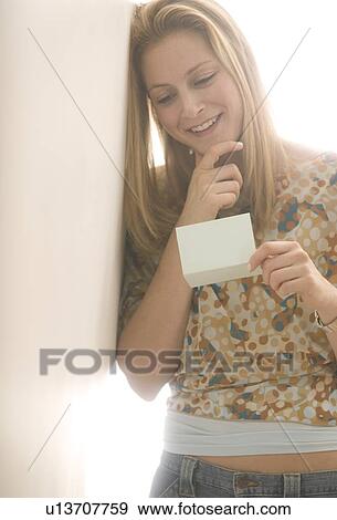 Stock Photo - Young female reading a note. Fotosearch