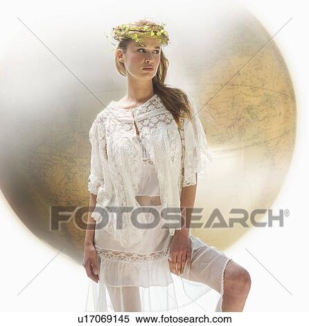 Stock Photography - Young female with large globe in background. Fotosearch