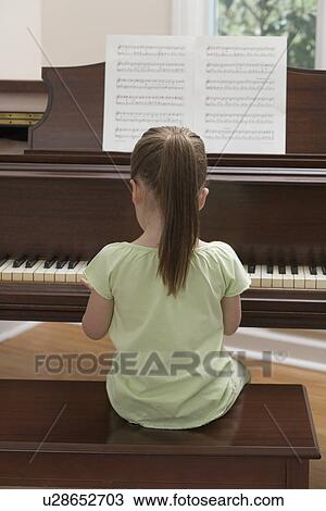 Young girl playing piano View Large Photo Image Stock Image - Young girl playing piano. Fotosearch