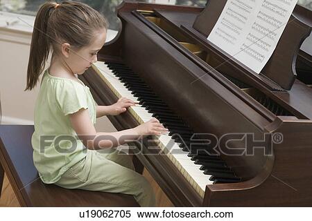 Young girl playing piano View Large Photo Image Stock Photography - Young girl playing piano. Fotosearch