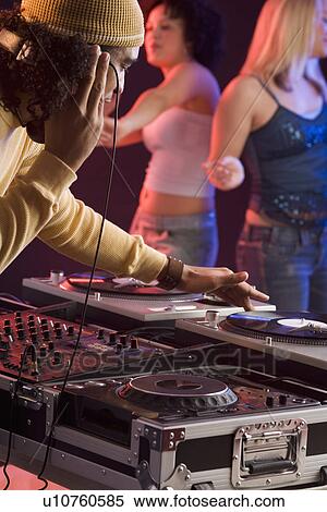Stock Photography - Young man playing music at a dance club. Fotosearch